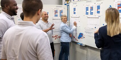 Produktionsmeeting mit Qualitätskontrolle Teammeeting vor Produktionsplänen mit Qualitätskontrolldiagrammen