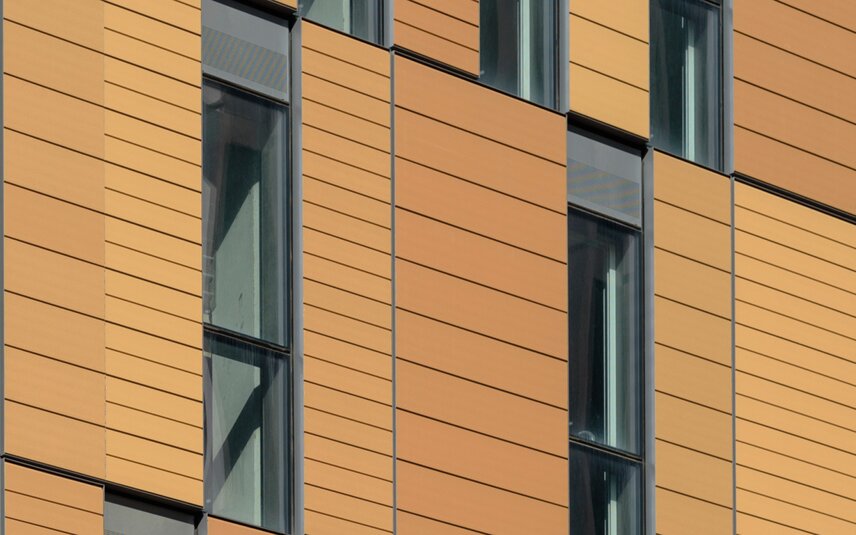 Moderne Fassade mit orangefarbenen Fassadenplatten Moderne Gebäudeaußenwand mit Fassadenplatten